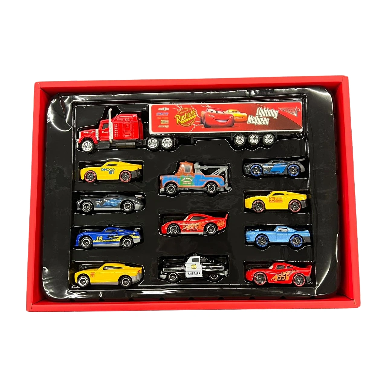 Set me 12 automjete lodër McQueen, i përbërë nga një kamion dhe 11 makina të vogla metalike me ngjyra dhe dizajne të ndryshme, ideal për lojëra dhe argëtim